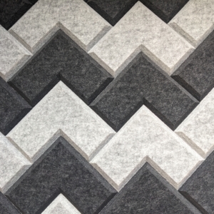 Motif géométrique en zigzag gris et noir avec un effet texturé, stratifié et tridimensionnel.
